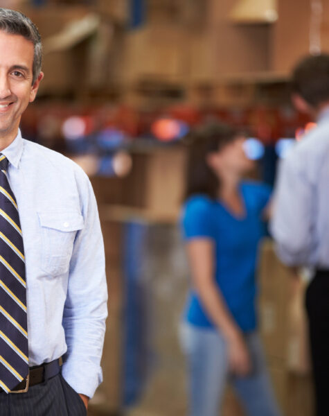 Portrait Of Manager In Warehouse Smiling To Camera